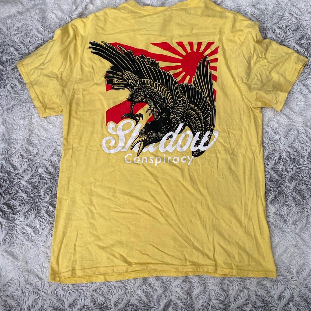 Yellow shadow conspiracy graphic tee